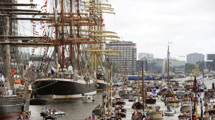 People visit ships mooring in the eastern harbour of the Amsterdam on August 20, 2010 as they attend the maritime manifestation "SAIL Amsterdam" held every five years, gathering tall ships from all over the world. AFP PHOTO/ ANP/ MARCEL ANTONISSE ***NETHERLANDS OUT - BELGIUM OUT*** (Photo credit should read MARCEL ANTONISSE/AFP/Getty Images)