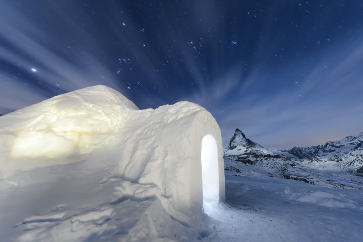 The Jan. 28, 2016 long-time exposure photo shows an Igloo at the "Igloo village" (Iglu Dorf) in front of the famous Matterhorn mountain in Zermatt, Switzerland. The hotel-igloo village made of snow and ice at 2'815 meters about sea level with a bar, a restaurant, bedrooms and wellness celebrates its 20th anniversary. (Jean-Christophe Bott/Keystone via AP)